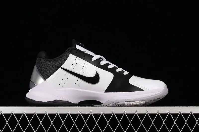 Side view of Nike Kobe 5 Protro in White/Black colorway showing the low-profile silhouette, black Nike Swoosh, and synthetic upper with fused overlays