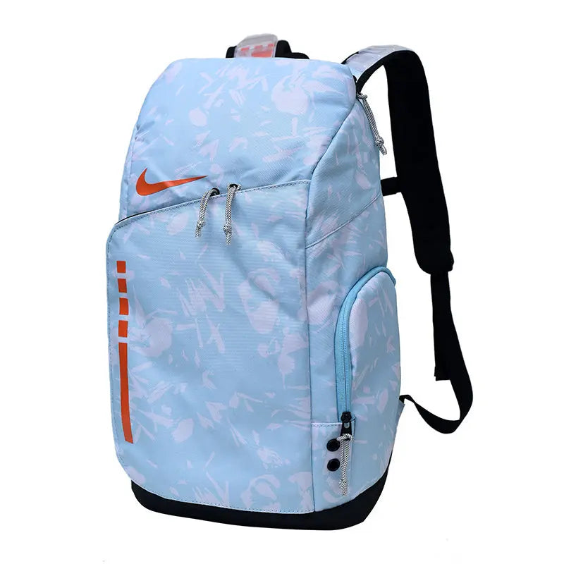 A light blue Nike backpack with a white graffiti-style pattern, orange swoosh logo, and black straps, shown on a plain white background.