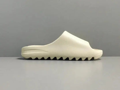 "adidas Yeezy Slide x Bone – sleek beige slide with soft EVA foam, minimalist design, and ridged outsole for comfort and traction."