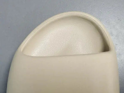 "adidas Yeezy Slide x Bone – sleek beige slide with soft EVA foam, minimalist design, and ridged outsole for comfort and traction."