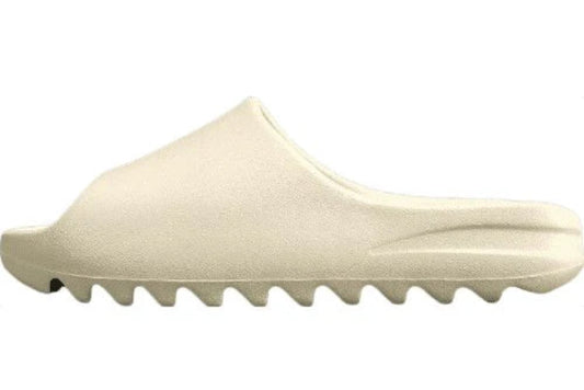 "adidas Yeezy Slide x Bone – sleek beige slide with soft EVA foam, minimalist design, and ridged outsole for comfort and traction."