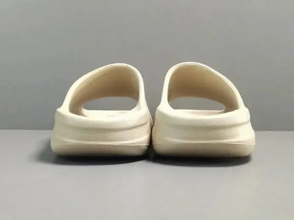 "adidas Yeezy Slide x Bone – sleek beige slide with soft EVA foam, minimalist design, and ridged outsole for comfort and traction."