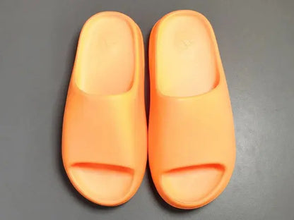 "adidas Yeezy Slide x Enflame Orange – vibrant orange slide with soft EVA foam, minimalist design, and ridged outsole for comfort and traction."