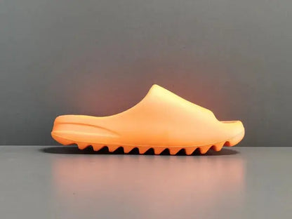 "adidas Yeezy Slide x Enflame Orange – vibrant orange slide with soft EVA foam, minimalist design, and ridged outsole for comfort and traction."