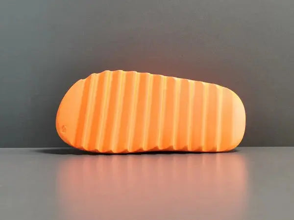 "adidas Yeezy Slide x Enflame Orange – vibrant orange slide with soft EVA foam, minimalist design, and ridged outsole for comfort and traction."