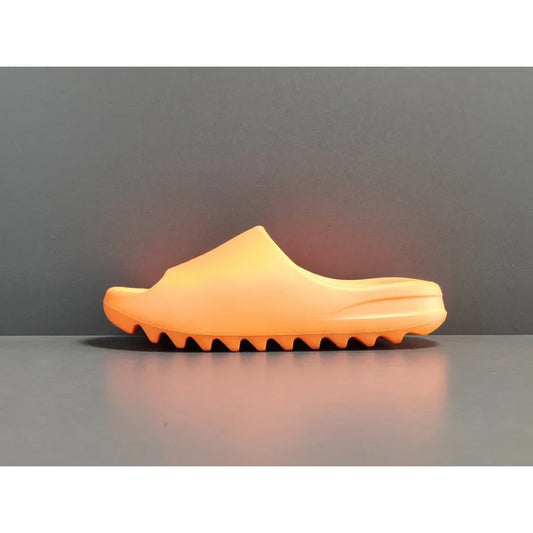 "adidas Yeezy Slide x Enflame Orange – vibrant orange slide with soft EVA foam, minimalist design, and ridged outsole for comfort and traction."