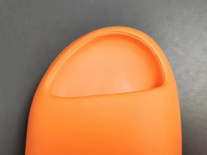 "adidas Yeezy Slide x Enflame Orange – vibrant orange slide with soft EVA foam, minimalist design, and ridged outsole for comfort and traction."