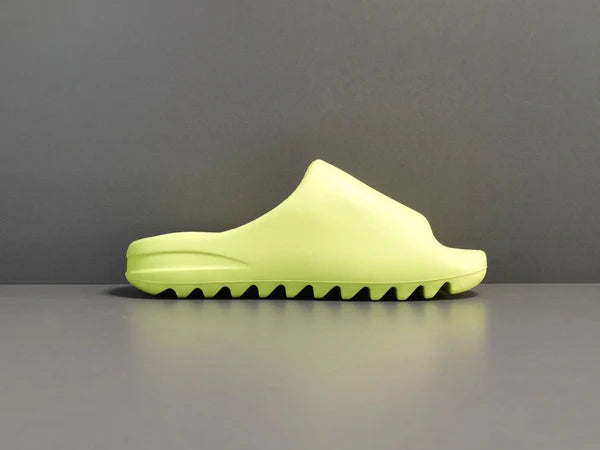 "adidas Yeezy Slide x Glow Green – vibrant neon-green slide with soft EVA foam, minimalist design, and ridged outsole for comfort and traction."