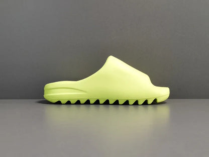 "adidas Yeezy Slide x Glow Green – vibrant neon-green slide with soft EVA foam, minimalist design, and ridged outsole for comfort and traction."