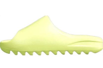"adidas Yeezy Slide x Glow Green – vibrant neon-green slide with soft EVA foam, minimalist design, and ridged outsole for comfort and traction."