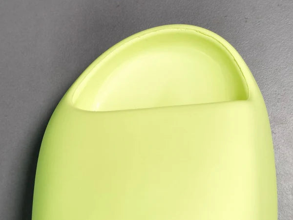 "adidas Yeezy Slide x Glow Green – vibrant neon-green slide with soft EVA foam, minimalist design, and ridged outsole for comfort and traction."