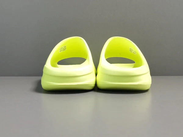 "adidas Yeezy Slide x Glow Green – vibrant neon-green slide with soft EVA foam, minimalist design, and ridged outsole for comfort and traction."