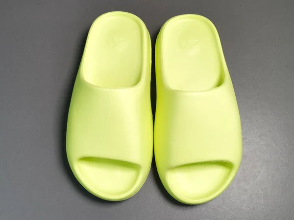 "adidas Yeezy Slide x Glow Green – vibrant neon-green slide with soft EVA foam, minimalist design, and ridged outsole for comfort and traction."