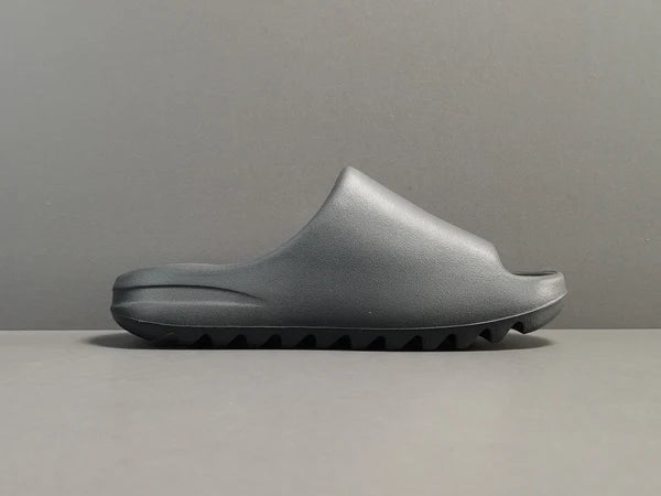 "adidas Yeezy Slide x Onyx – sleek all-black slide with soft EVA foam, minimalist design, and ridged outsole for comfort and grip."