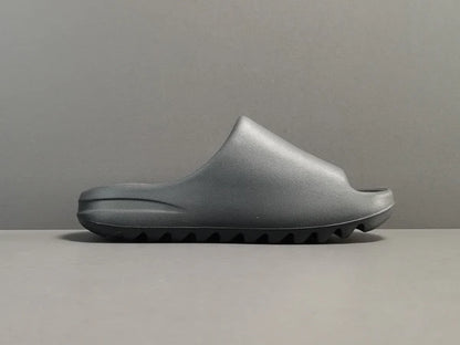 "adidas Yeezy Slide x Onyx – sleek all-black slide with soft EVA foam, minimalist design, and ridged outsole for comfort and grip."