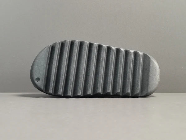 "adidas Yeezy Slide x Onyx – sleek all-black slide with soft EVA foam, minimalist design, and ridged outsole for comfort and grip."