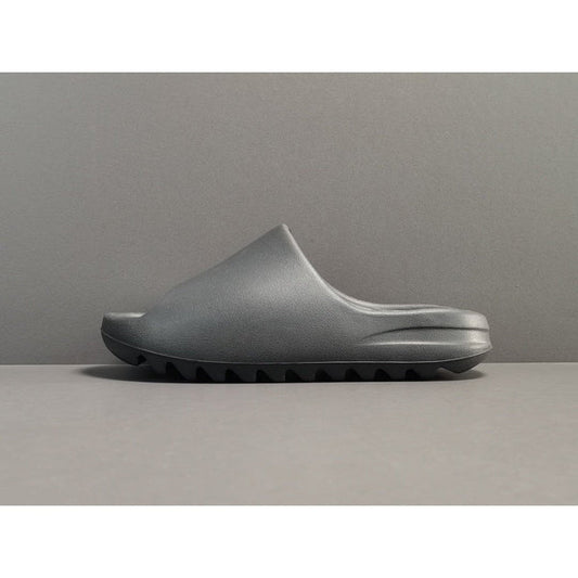 "adidas Yeezy Slide x Onyx – sleek all-black slide with soft EVA foam, minimalist design, and ridged outsole for comfort and grip."