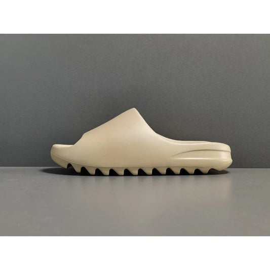 "adidas Yeezy Slide x Pure – neutral-tone slide with soft EVA foam, minimalist design, and ridged outsole for comfort and traction."