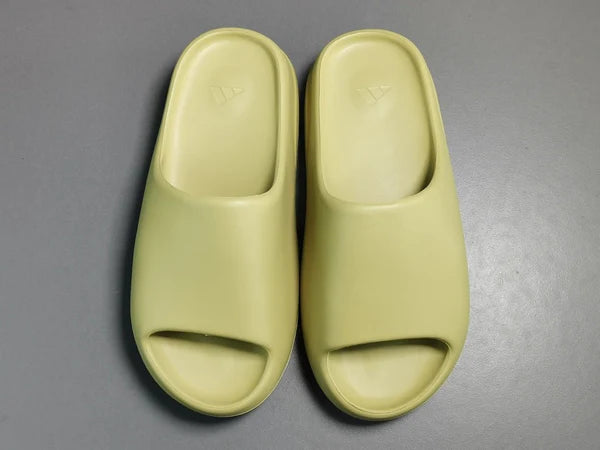 "adidas Yeezy Slide x Resin – earthy green slide with soft EVA foam, minimalist design, and ridged outsole for comfort and traction."