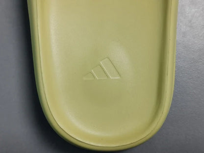 "adidas Yeezy Slide x Resin – earthy green slide with soft EVA foam, minimalist design, and ridged outsole for comfort and traction."