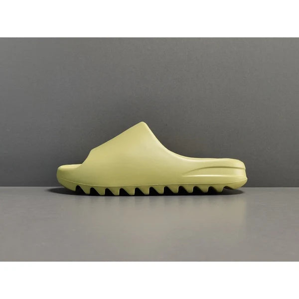 "adidas Yeezy Slide x Resin – earthy green slide with soft EVA foam, minimalist design, and ridged outsole for comfort and traction."