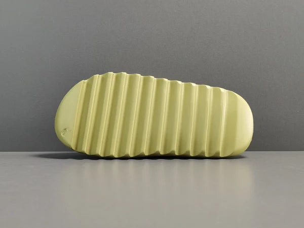 "adidas Yeezy Slide x Resin – earthy green slide with soft EVA foam, minimalist design, and ridged outsole for comfort and traction."