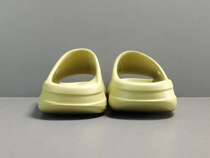 "adidas Yeezy Slide x Resin – earthy green slide with soft EVA foam, minimalist design, and ridged outsole for comfort and traction."