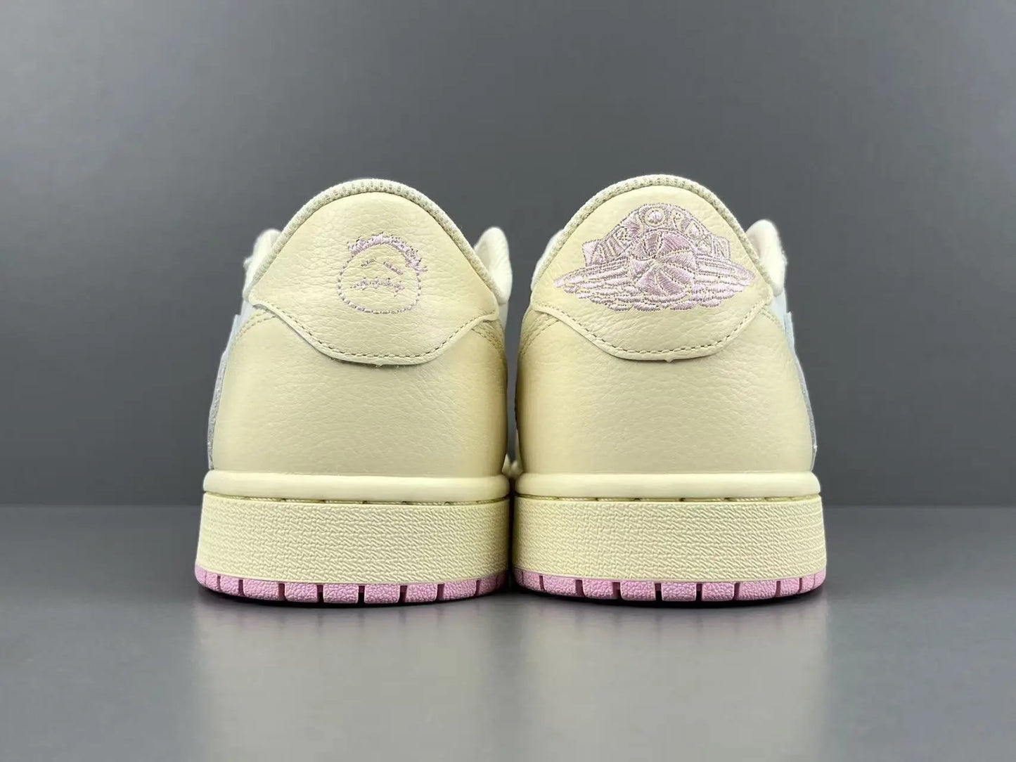 Jordan 1 Low Travis Scott Muslin Shy Pink sneakers with reverse Swoosh

