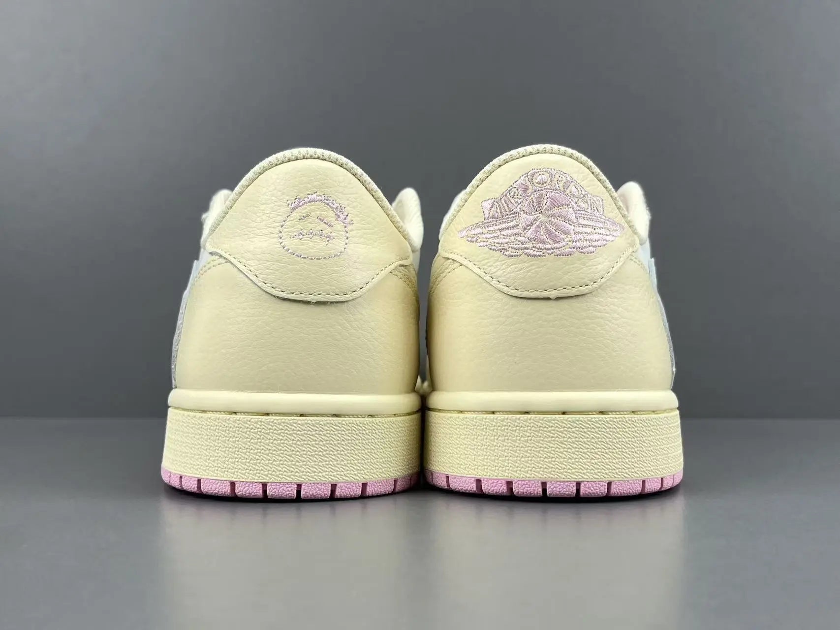 Jordan 1 Low Travis Scott Muslin Shy Pink sneakers with reverse Swoosh
