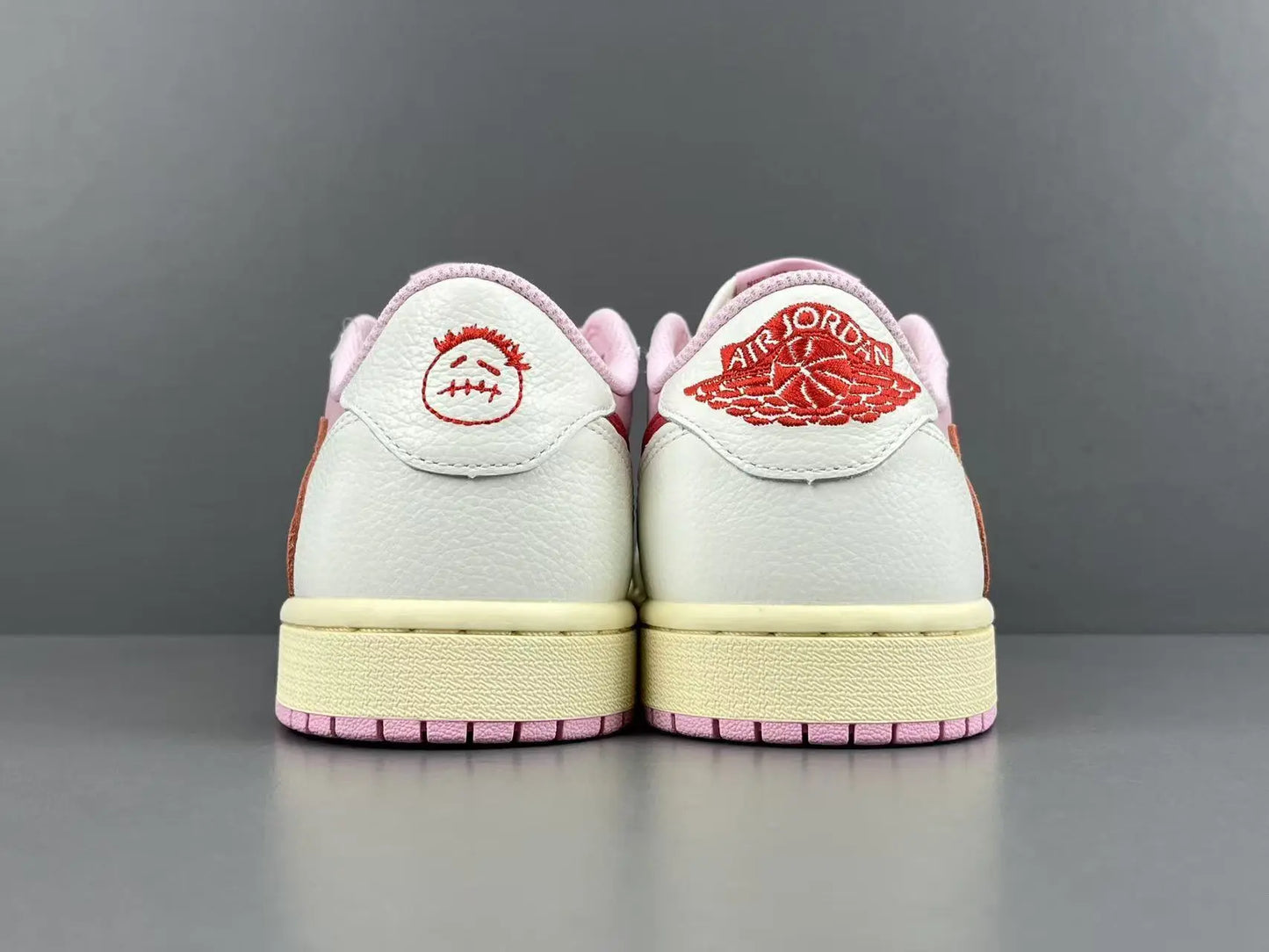 Jordan 1 Low Travis Scott Tropical Pink sneakers with reverse Swoosh
