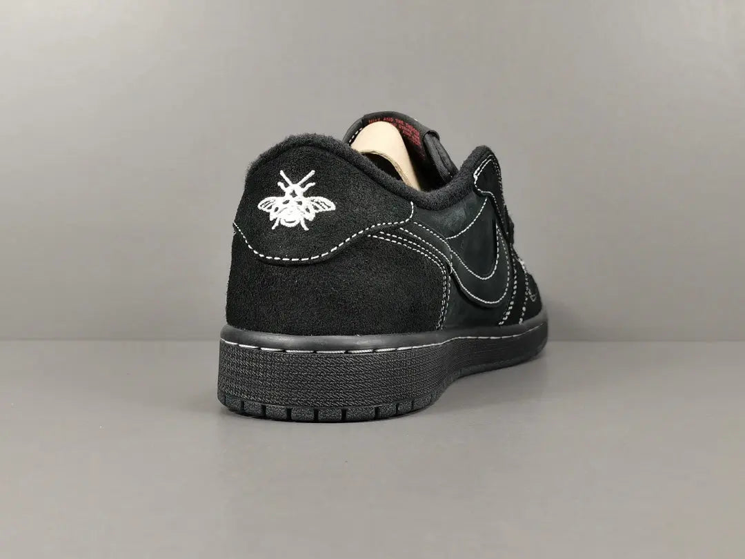 "Jordan 1 Low Travis Scott Phantom with black nubuck, white stitching, and signature reverse Swoosh."