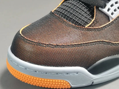Close-up of a brown athletic shoe with orange sole on a gray background