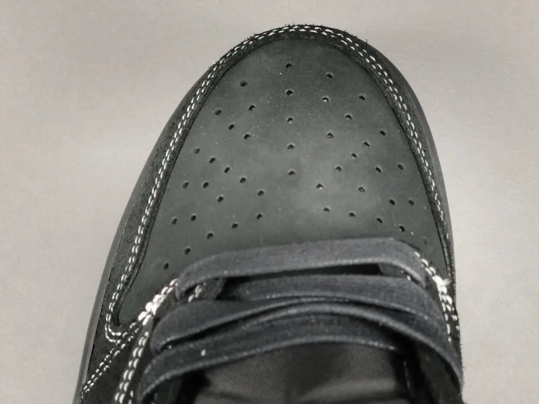 "Jordan 1 Low Travis Scott Phantom with black nubuck, white stitching, and signature reverse Swoosh."