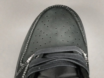 "Jordan 1 Low Travis Scott Phantom with black nubuck, white stitching, and signature reverse Swoosh."