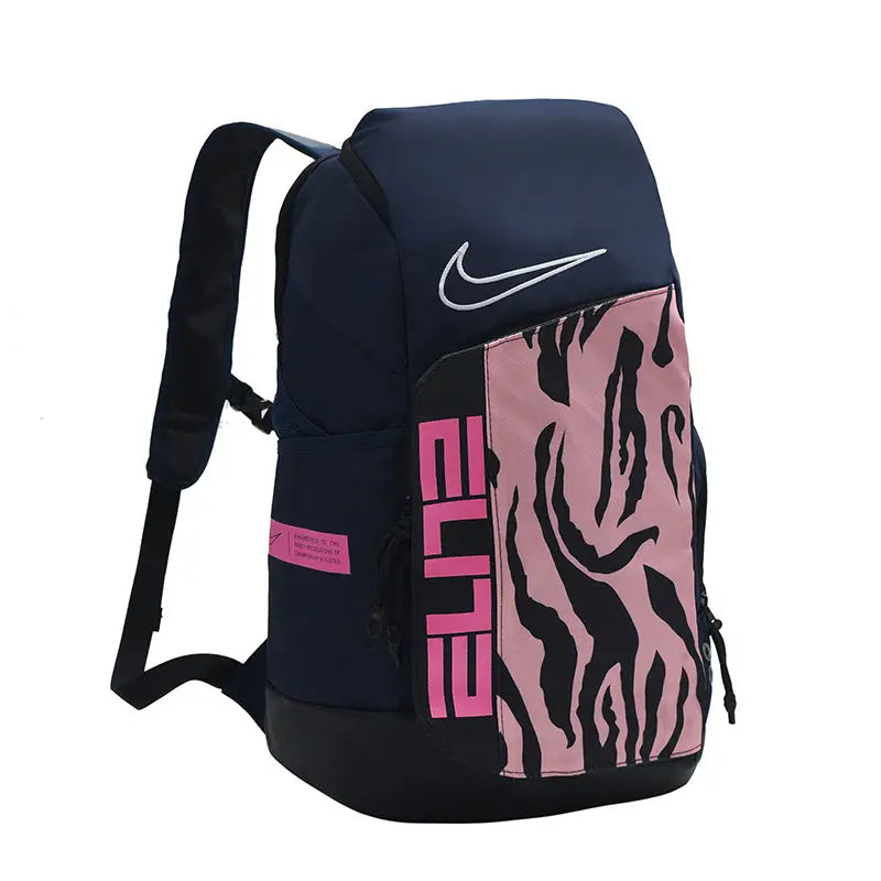 A Nike backpack in navy blue with a pink and black patterned front pocket, featuring a white Nike swoosh and pink 'ELITE' lettering.