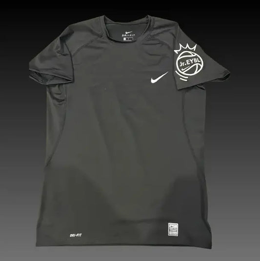 A black Nike athletic t-shirt with a white swoosh on the chest and a white J.League crown logo on the sleeve, displayed against a dark gradient background.