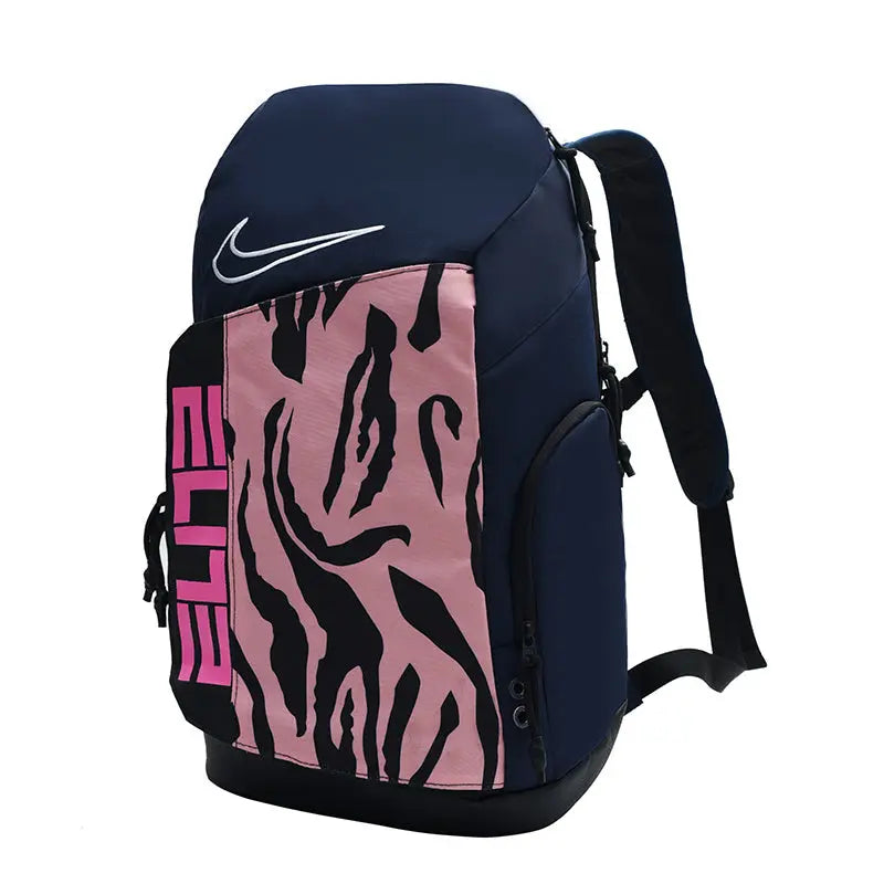 A Nike backpack in navy blue, pink, and black, featuring a pink and black tiger-stripe pattern on the front pocket, a white Nike swoosh, and the word 'ELITE' in pink on a black side panel.
