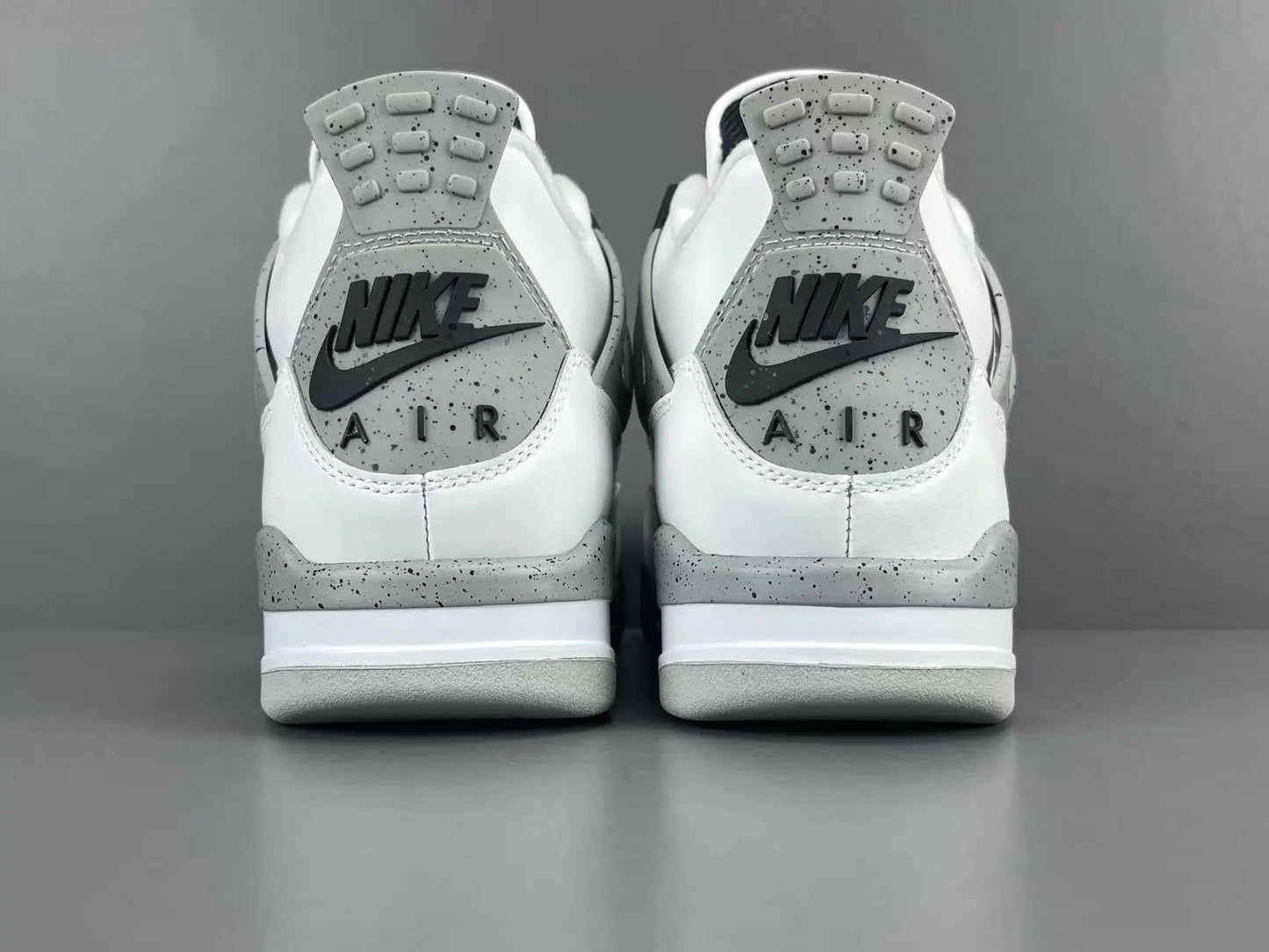 Air Jordan 4 White Cement sneakers with iconic cement print and design
