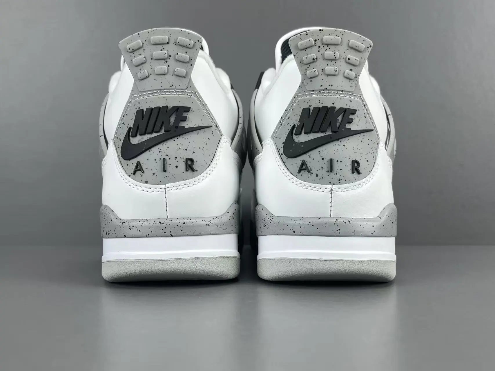 Air Jordan 4 White Cement sneakers with iconic cement print and design
