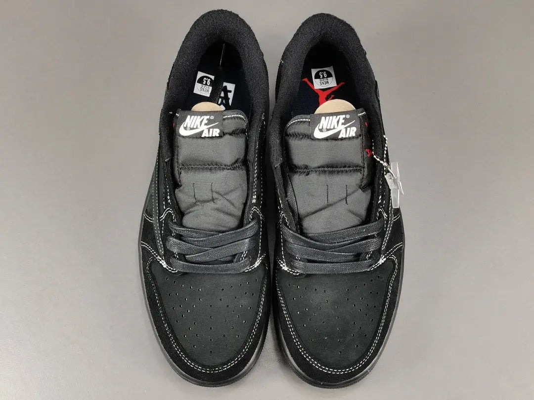 "Jordan 1 Low Travis Scott Phantom with black nubuck, white stitching, and signature reverse Swoosh."