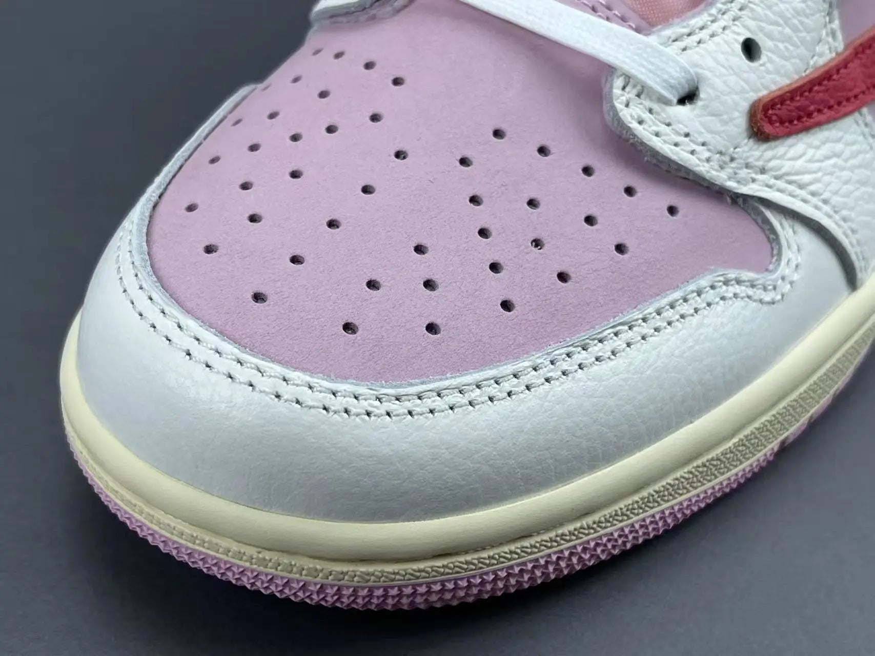 Jordan 1 Low Travis Scott Tropical Pink sneakers with reverse Swoosh
