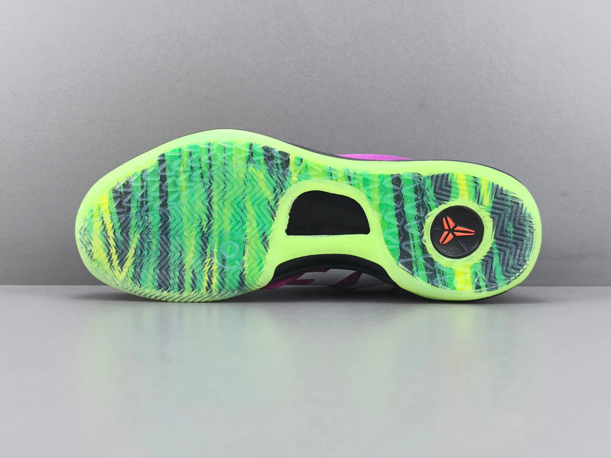 The outsole of a basketball shoe featuring a vibrant neon green and black wavy pattern, with a black heel containing a red circular logo, set against a neutral gray background.