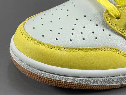 "Jordan 1 Low OG x Canary – low-top sneaker with premium leather upper, bright yellow and white colorway, and classic retro design."