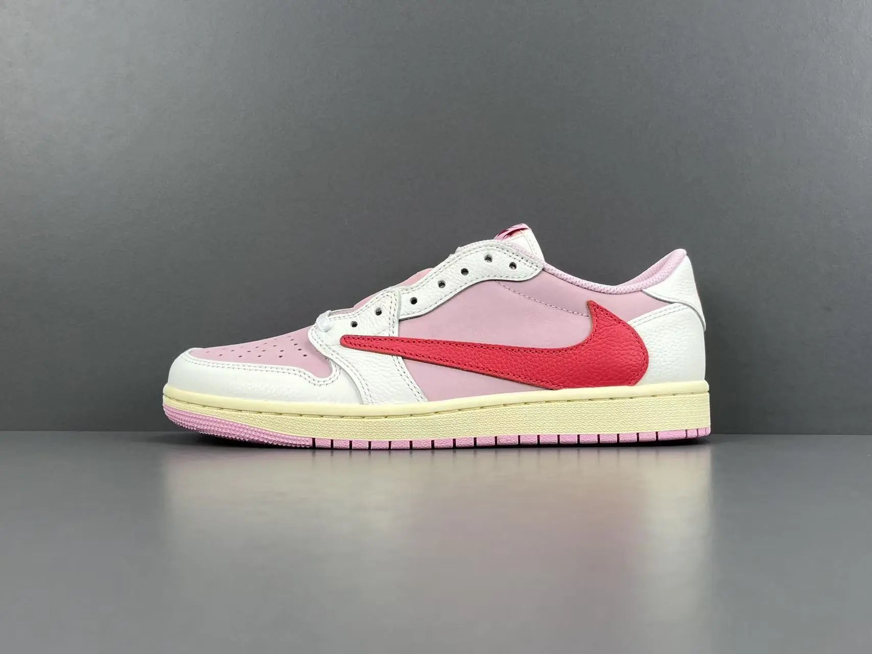 Jordan 1 Low Travis Scott Tropical Pink sneakers with reverse Swoosh
