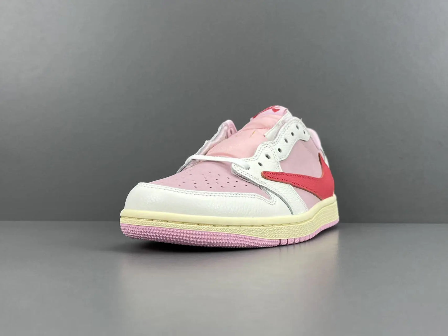 Jordan 1 Low Travis Scott Tropical Pink sneakers with reverse Swoosh

