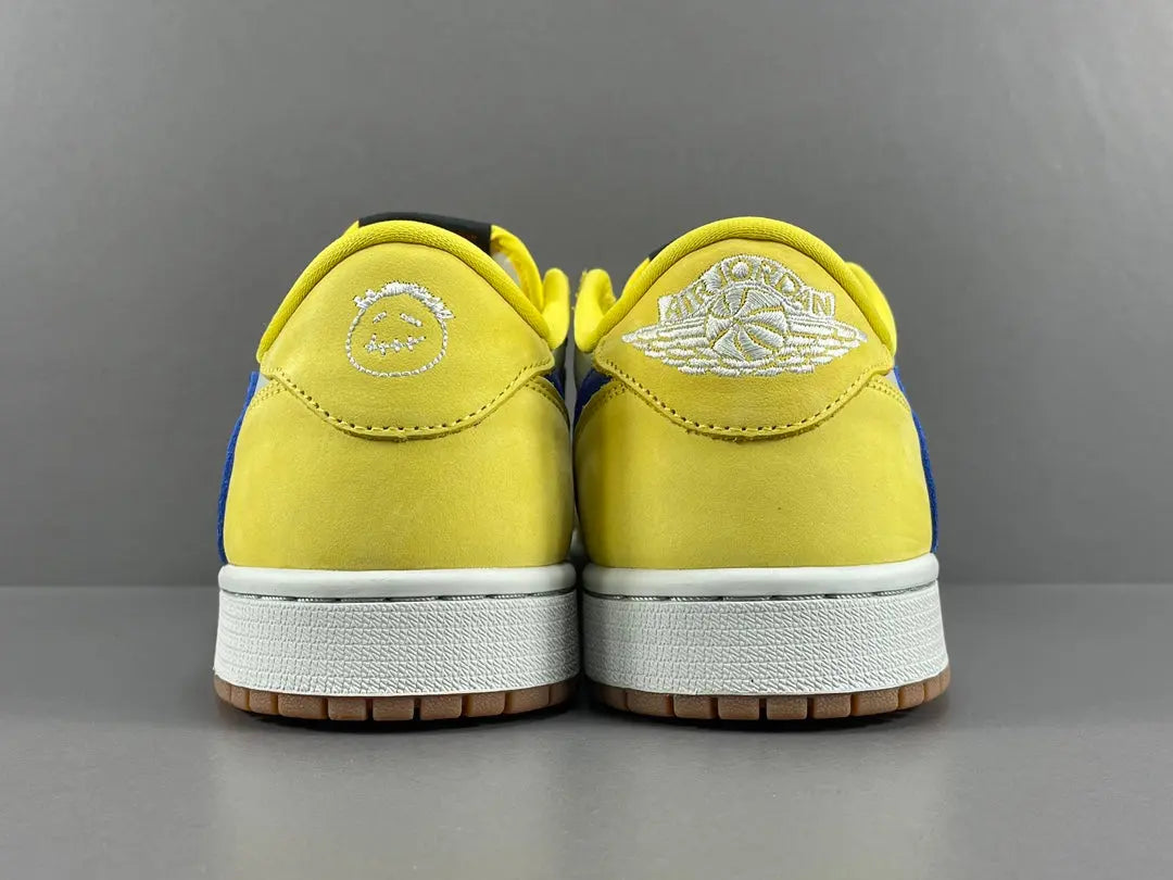 "Jordan 1 Low OG x Canary – low-top sneaker with premium leather upper, bright yellow and white colorway, and classic retro design."