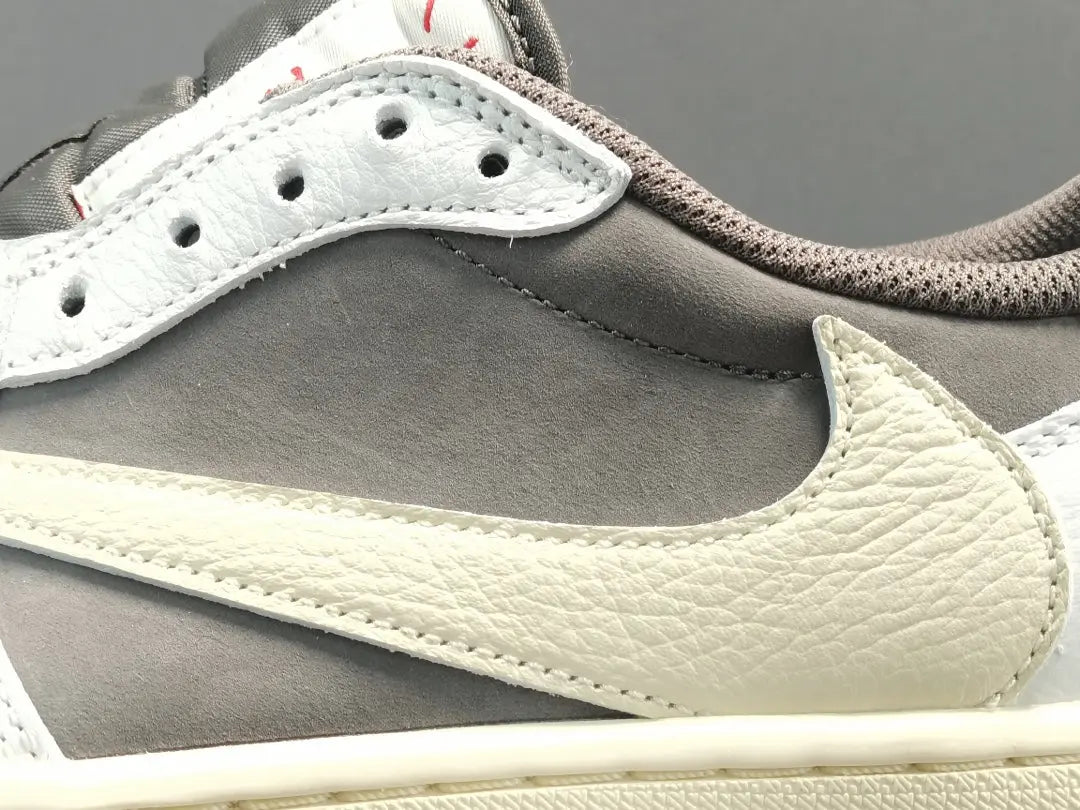 "Jordan 1 Low x Travis Scott Reverse Mocha – Mocha suede, reverse Swoosh, Cactus Jack branding, and vintage sail accents."