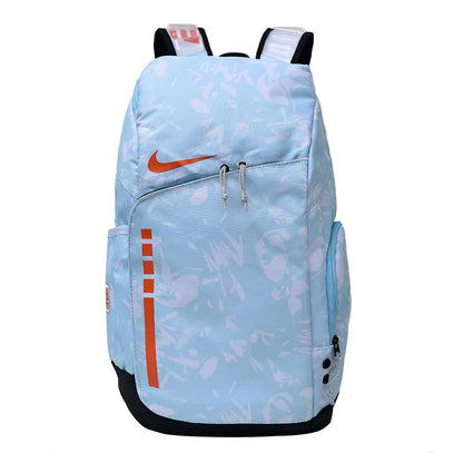 A light blue Nike backpack with an abstract white pattern, orange swoosh logo, and orange vertical stripe detail on the front pocket, shown against a plain white background.