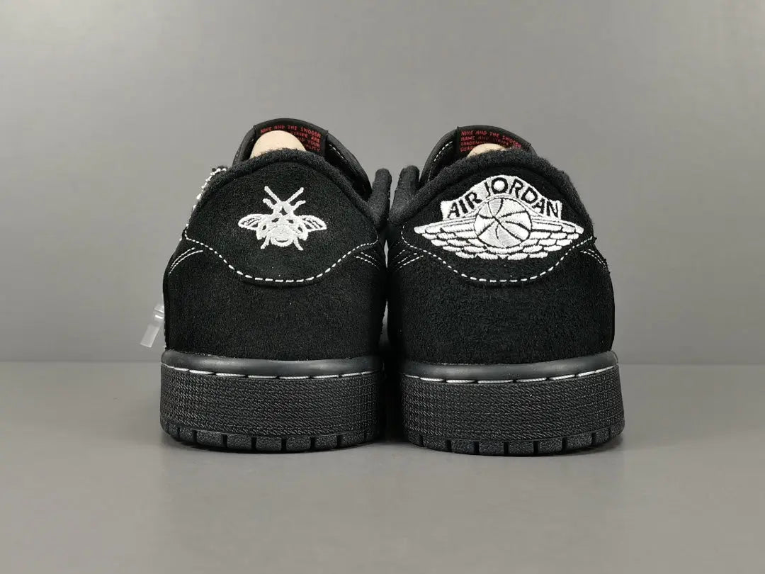 "Jordan 1 Low Travis Scott Phantom with black nubuck, white stitching, and signature reverse Swoosh."