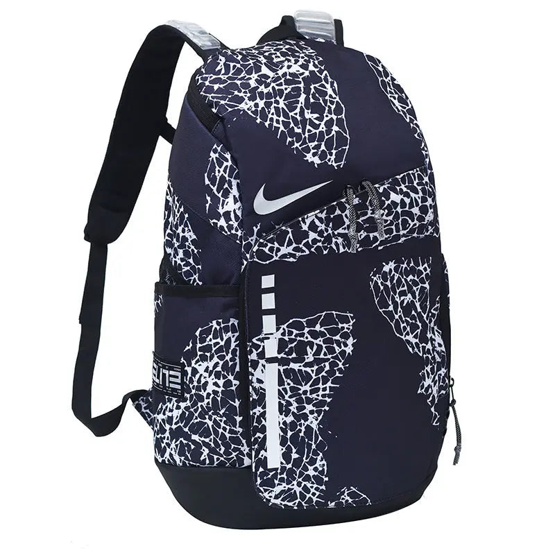 A Nike backpack in navy blue with a white abstract cracked pattern, featuring a white Nike swoosh on the front pocket.